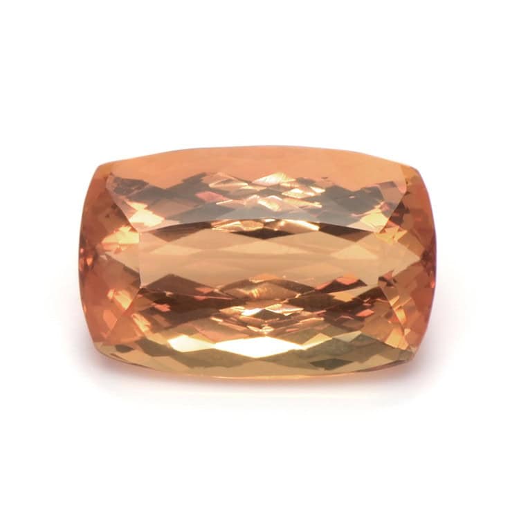 Cushion cut Imperial Topaz gemstone with peach-orange color for jewelry.